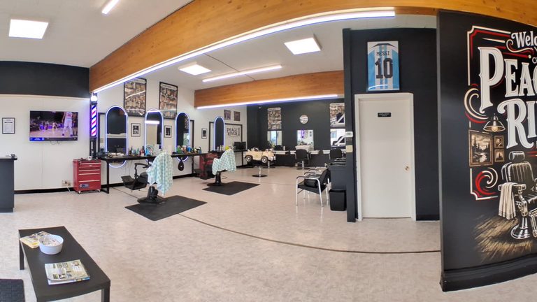 Mirrors and barber stations inside Peace River Barbershop